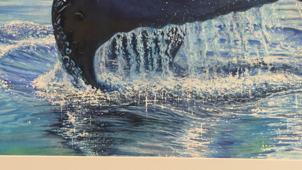 A close-up of watercolor painting of a whale tail and  ocean water, with blue and white splashing water and a dark whale body visible above the surface.